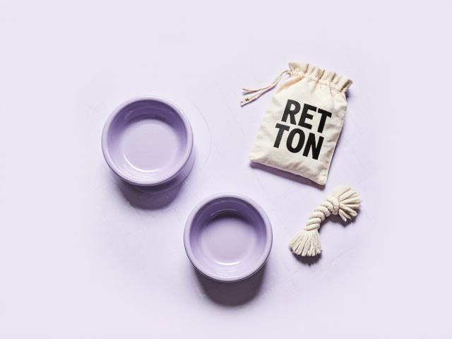 Curated selection of puppy supplies including ceramic bowl and chew toys
